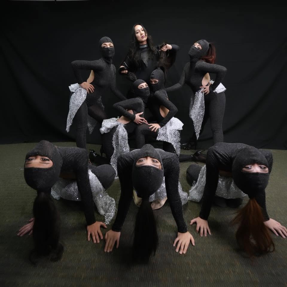 Contemporary dance ensemble in black costumes