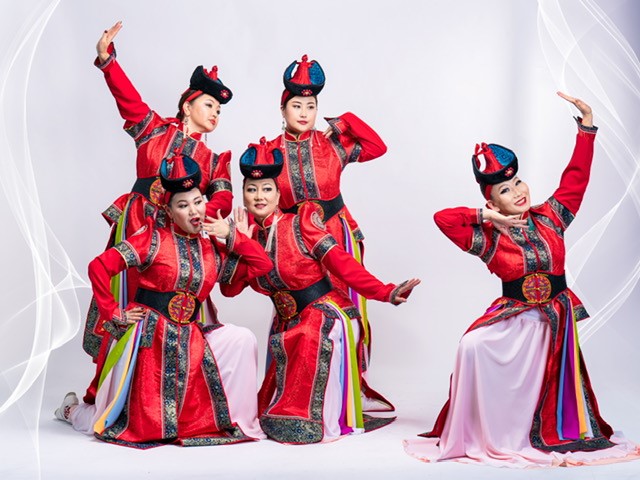 Five dancers in red Mongolian costumes and traditional hats
