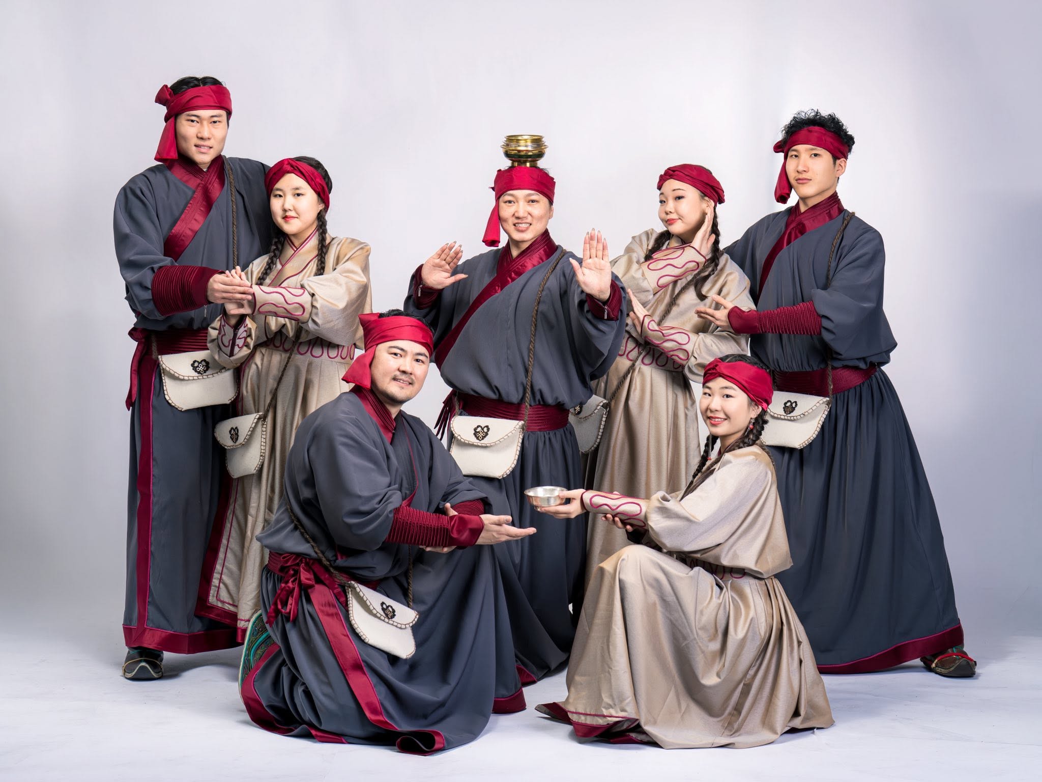 Dance ensemble in traditional grey and burgundy costumes